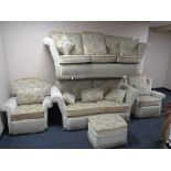 A five piece cream floral dralon lounge suite comprising of three seater settee, two seater settee,