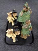 A tray containing four early 20th century chalk figures, ballet dancer, bride and groom etc.