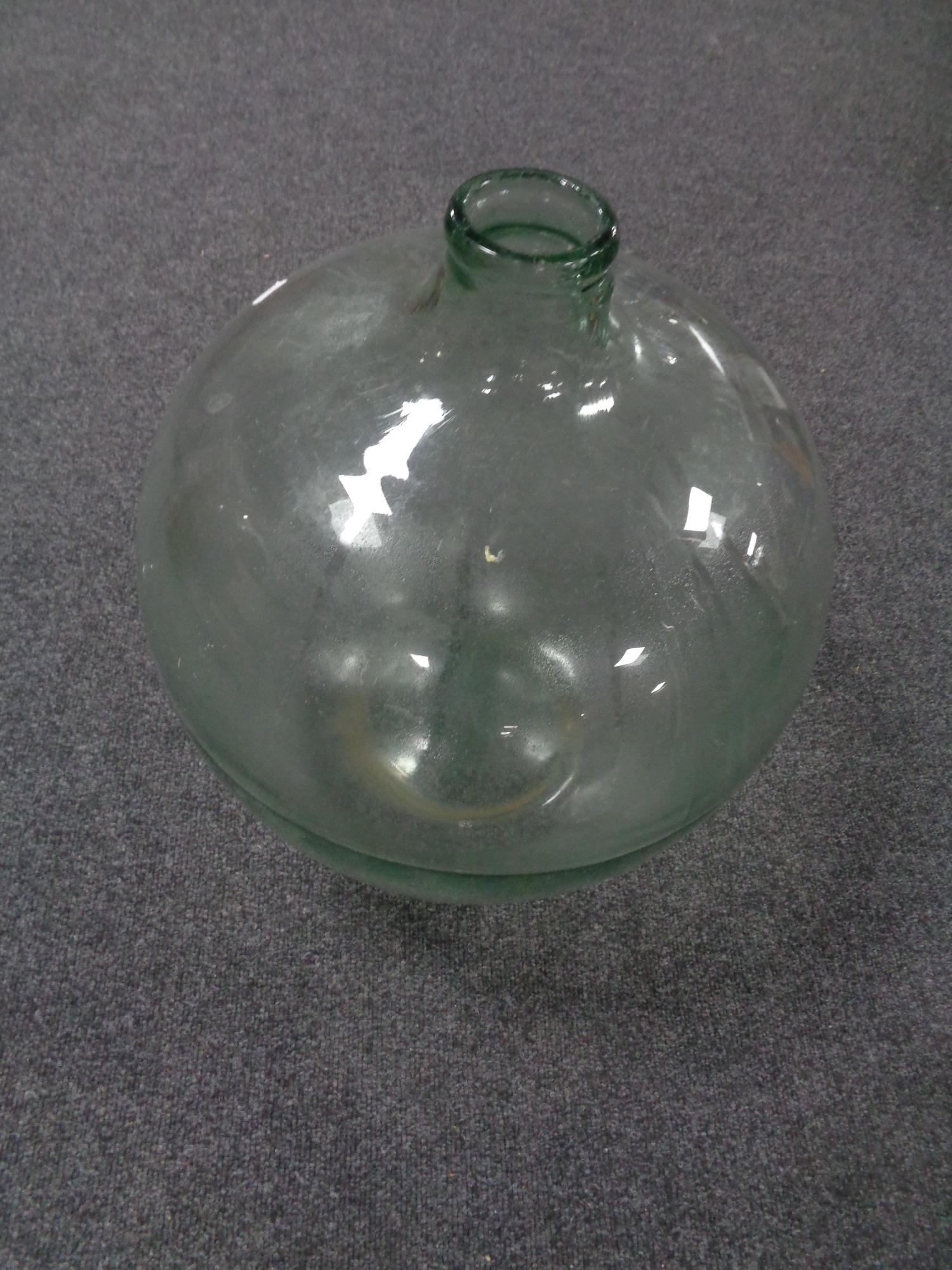 An antique glass carboy.