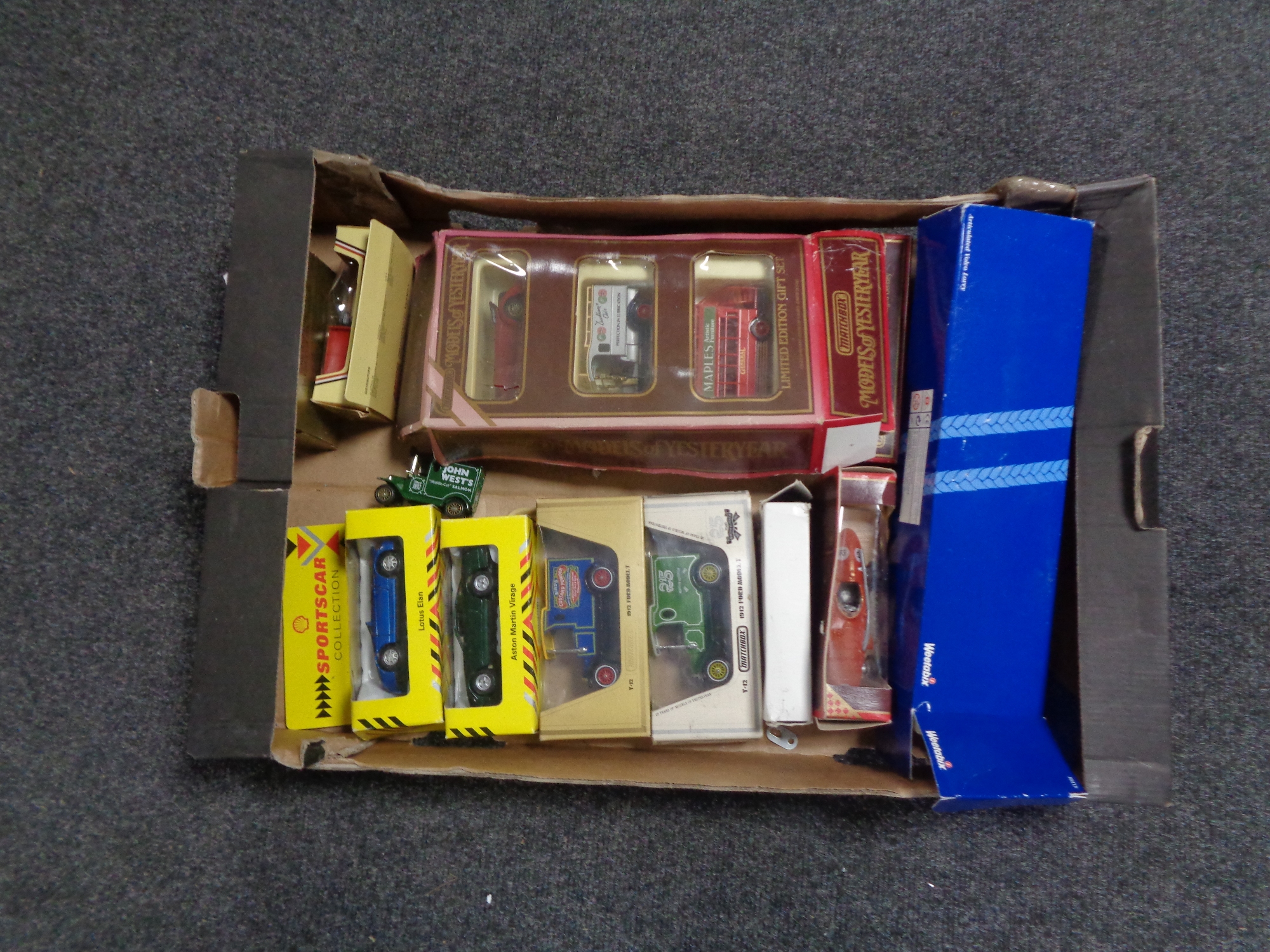 A box containing boxed die cast vehicles to include models of Yesteryear, Matchbox,