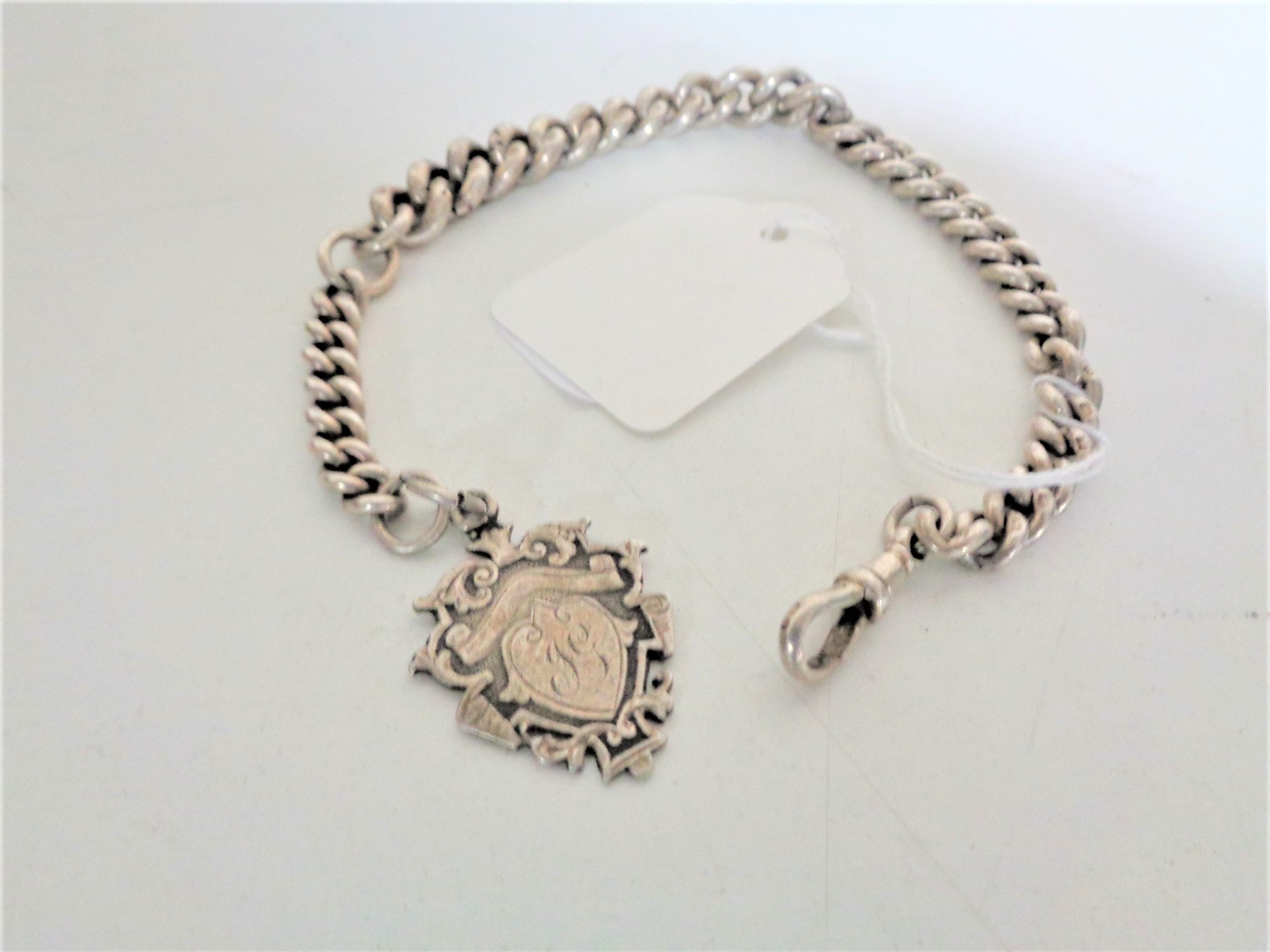 A silver graduated pocket watch chain with Sterling silver fob, dated 1911, 54.3g, length 27 cm.