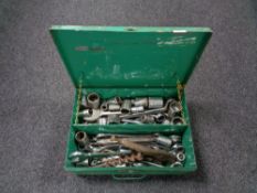 A metal tool box of assorted spanners,