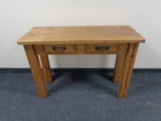 A Mexican pine console table fitted two drawers