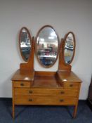 A 19th century inlaid mahogany sunk-centre dressing chest with triple mirror