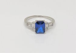 An Art Deco style sterling silver ring set with a blue stone,