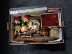 A box containing a boxed cheese board, lidded trinket boxes, shells, maracas,