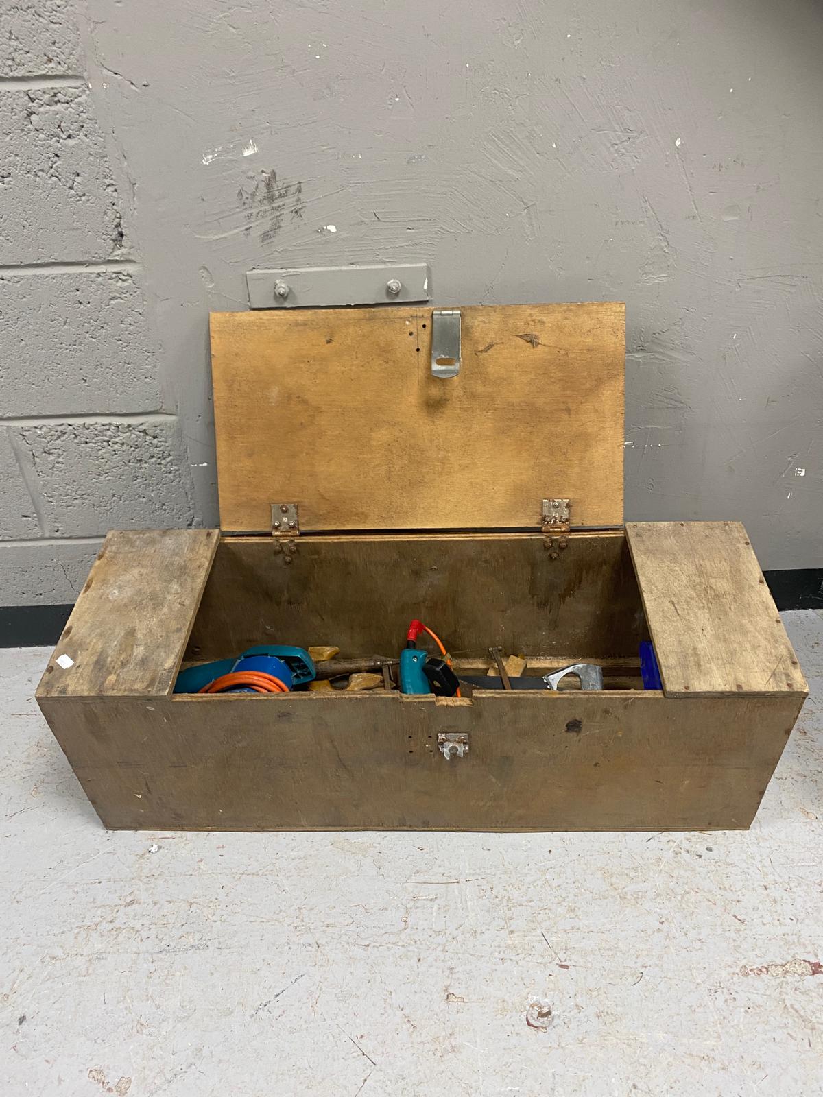 A joiner's tool box containing electric drill, belt sander,