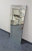 A contemporary all glass framed mirror