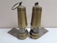 A pair of twentieth century brass bookends in the form of miner's lamps