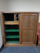 An Edwardian oak sliding door house keeping cabinet.