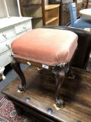 A Victorian mahogany dressing table stool on cabriole legs upholstered in a pink dralon.