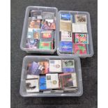Three plastic storage boxes with lids containing assorted CD's