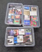 Three plastic storage boxes with lids containing assorted CD's