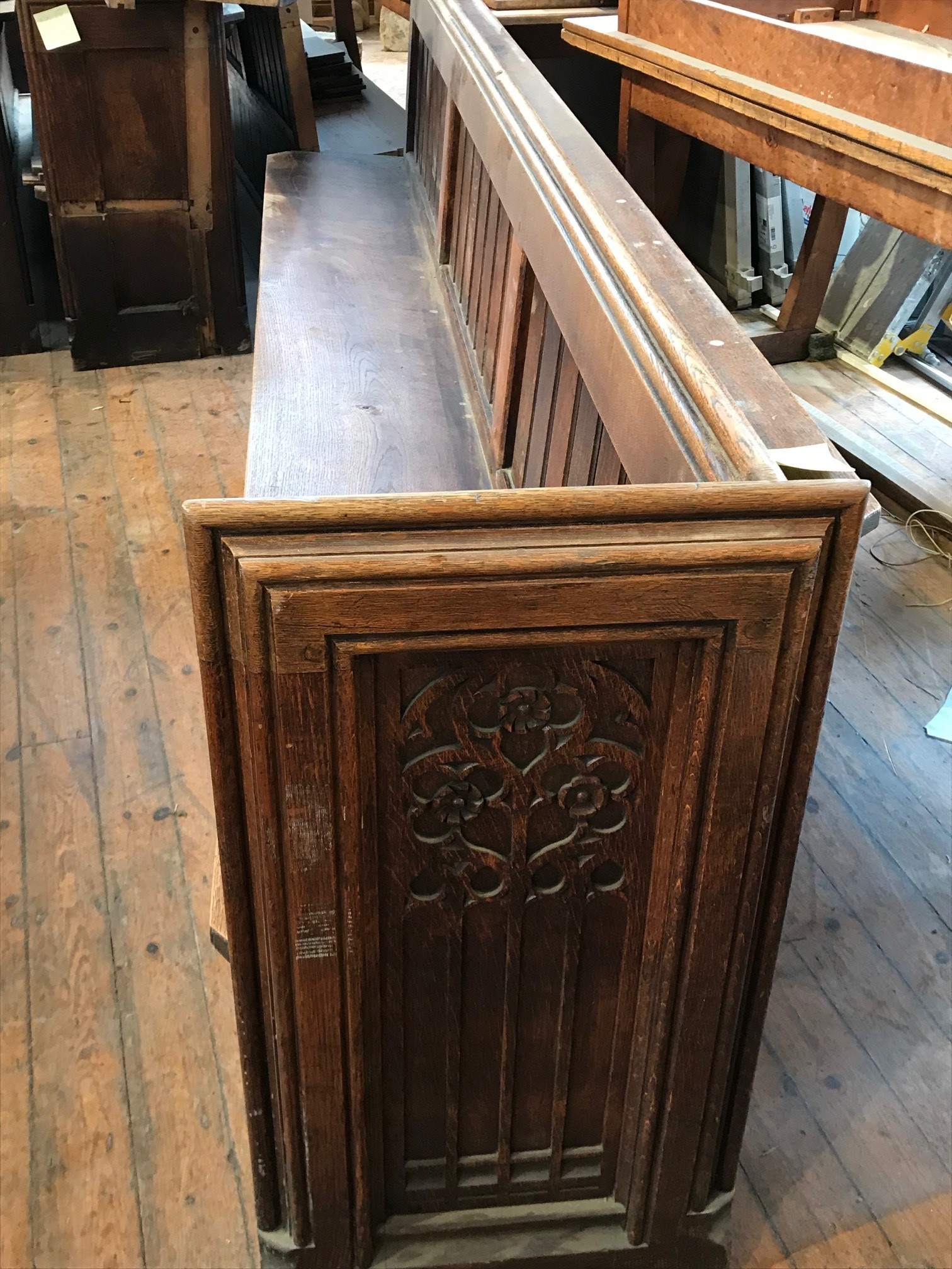 A two-section Gothic revival church pew, total length approximately 570 cm.