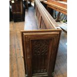 A two-section Gothic revival church pew, total length approximately 570 cm.