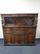 A carved oak buffet back sideboard.