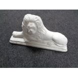 A painted composite door stop in the form of a lion