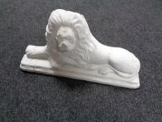 A painted composite door stop in the form of a lion