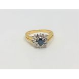 An 18ct gold sapphire and diamond cluster ring, size M CONDITION REPORT: 3.