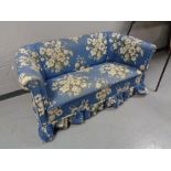 An early twentieth century settee in blue floral fabric