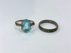 A 9ct gold and silver dress ring set with a blue stone, together with a 9ct and silver band ring.