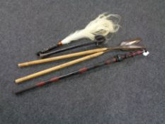 A tribal walking stick together with two wooden spears, a club and a fly swish.