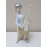 A Lladro figure of a boy with guitar