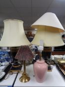 A pair of black and gold Grecian style table lamps with shades,