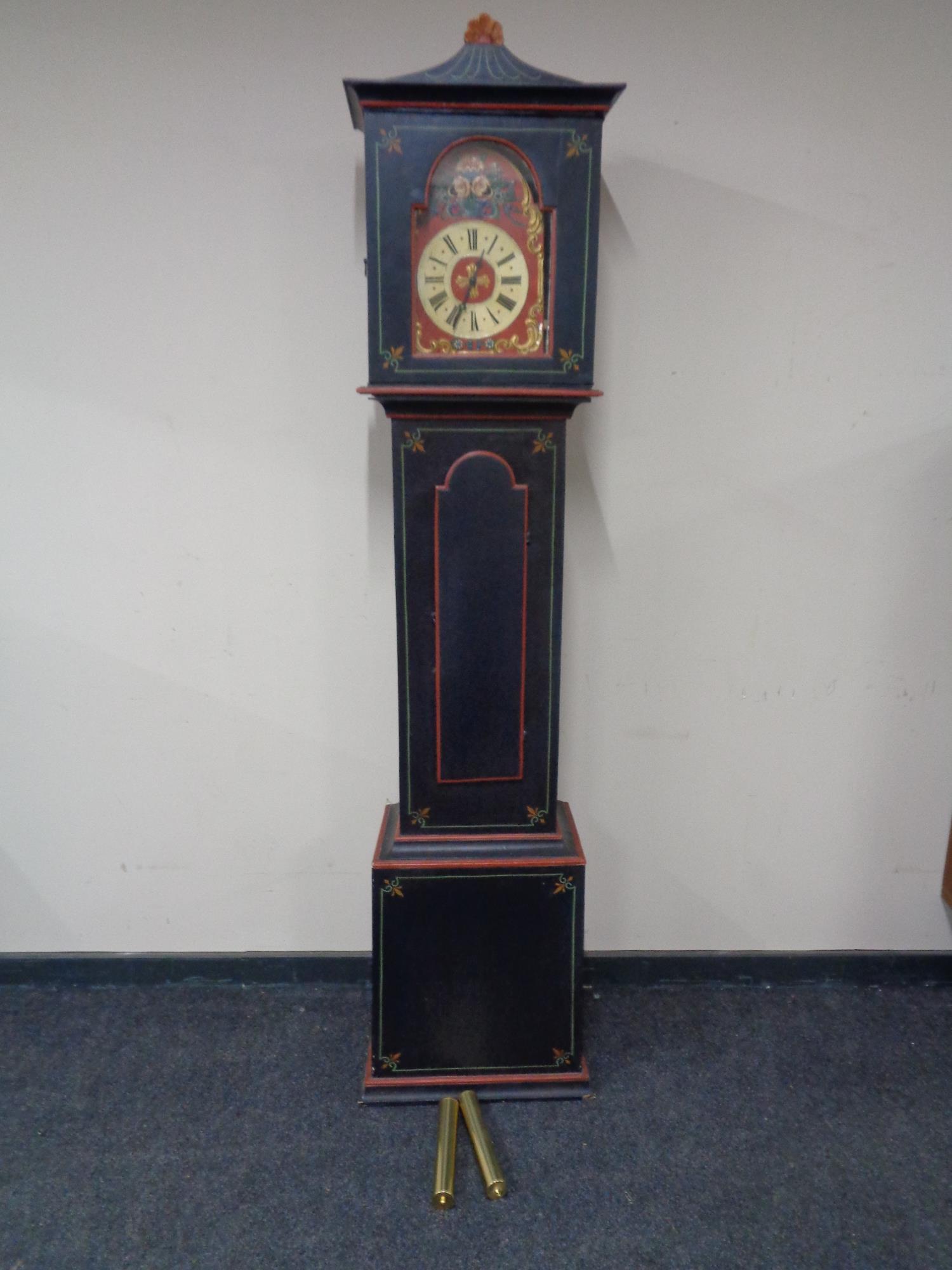 An early 20th century painted continental longcase clock with painted dial, pendulum and weights.
