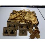 A tray of gilt metal door handles and finger plates,