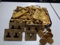 A tray of gilt metal door handles and finger plates,