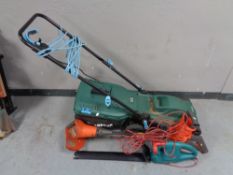 A McGregor electric vacuum together with a Flymo multi trim and a Bosch electric hedge trimmer.