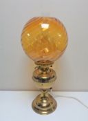 A brass Duplex oil lamp with amber glass shade and chimney (converted)