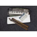 A Casio Casiotone MT-100 keyboard in carry bag together with a folding vintage music stand