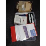 Three boxes containing a large quantity of world stamps and first day covers in albums and folders.