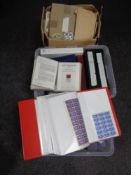 Three boxes containing a large quantity of world stamps and first day covers in albums and folders.