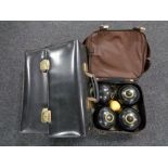 A lawn bowls bag containing four composite Taylor bowls and a leather briefcase