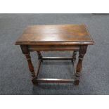 An antique oak jointed stool.