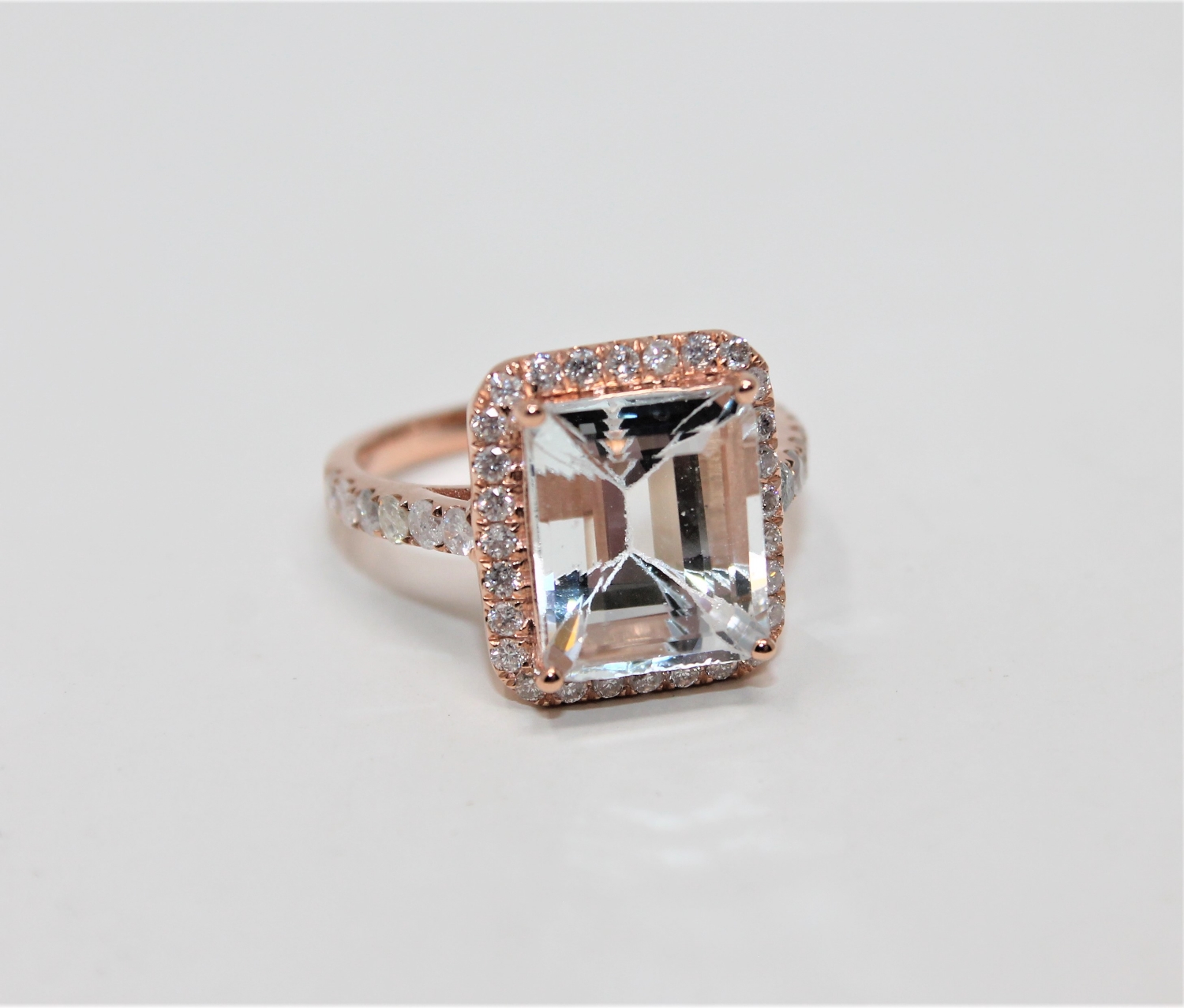 A 14ct rose gold aquamarine and diamond cluster ring,