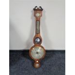 An early 19th century mahogany cased banjo barometer with silvered dial