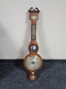 An early 19th century mahogany cased banjo barometer with silvered dial