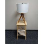 A pine breakfast bar stool together with a contemporary lamp on tripod stand.