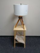 A pine breakfast bar stool together with a contemporary lamp on tripod stand.