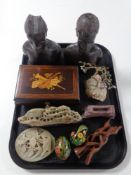 A tray containing musical jewellery box, carved hardwood African figures, tourist soapstone pieces,