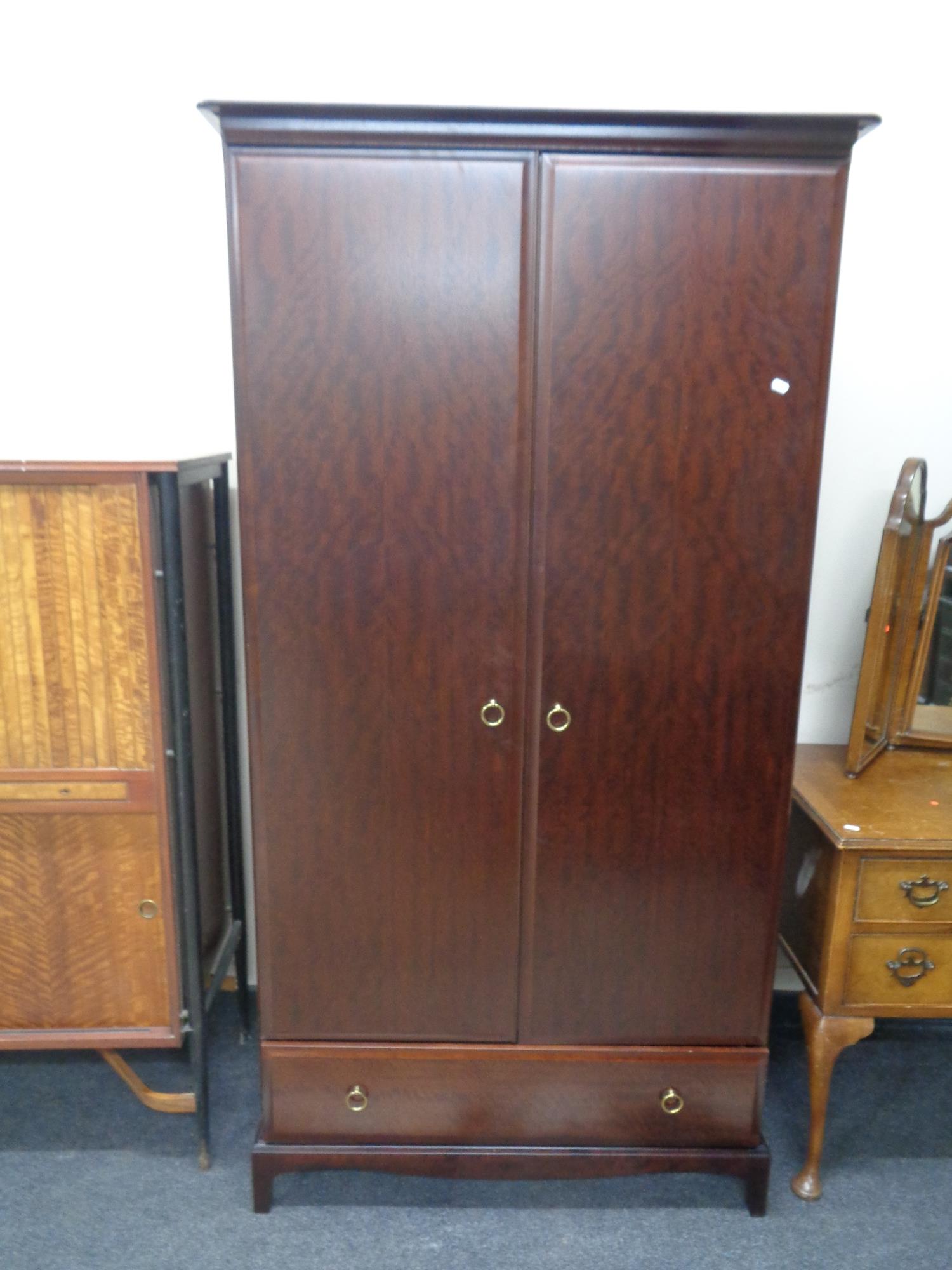 A Stag Minstrel double door wardrobe, fitted drawer beneath.