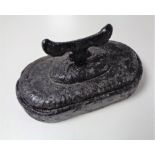 A cast iron boot scraper on painted stone base