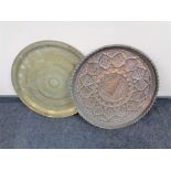 A circular Eastern brass wall plaque together with a further copper wall plaque