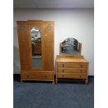 An Edwardian oak inlaid mirror door wardrobe, fitted a drawer beneath,