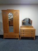 An Edwardian oak inlaid mirror door wardrobe, fitted a drawer beneath,