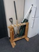 A pair of pine trestle stands together with a small quantity of garden tools,